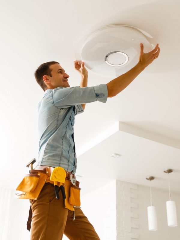 Electrician,Is,Installing,And,Connecting,A,Lamp,To,A,Ceiling.